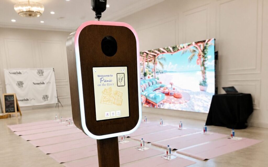 A vibrant photo booth setup with colorful props and a backdrop, showcasing luxury photo booth experiences Jacksonville.